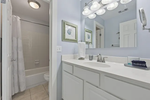 a bathroom with a sink a light fixture and a mirror