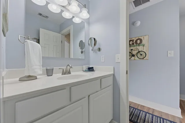 a bathroom with a sink a mirror and vanity