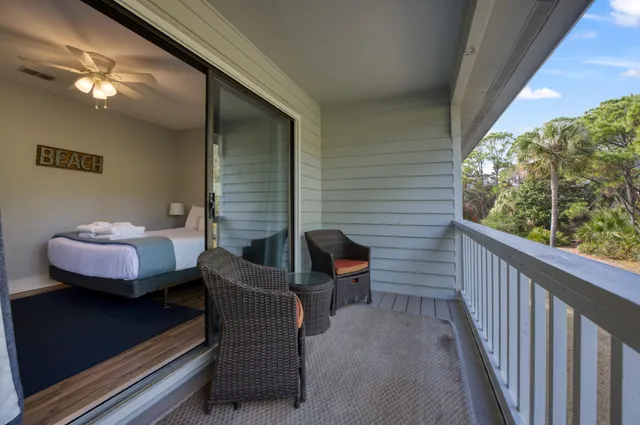 a balcony with furniture and a potted plant