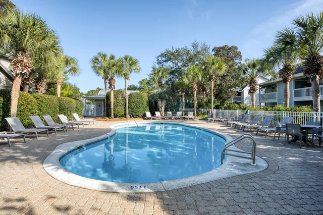 a view of a swimming pool with outdoor seating
