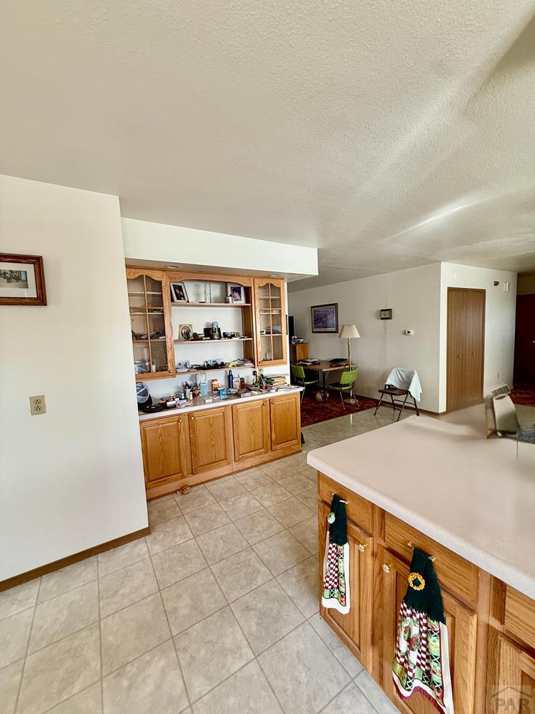 6216 Moreland Road Boone, CO 81025 - Photo 14 of 40 a living room with stainless steel appliances kitchen island granite countertop a sink and cabinets