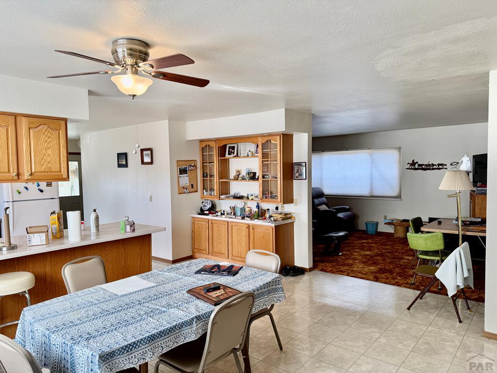 6216 Moreland Road Boone, CO 81025 - Photo 16 of 40 a living room with furniture a chandelier and a dining table