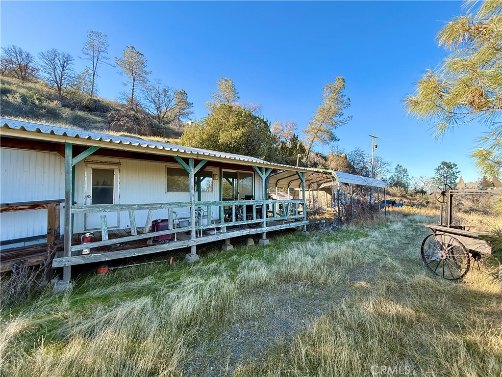 5847 West Whitlock Road Mariposa, CA 95338 - Photo 16 of 33 a backyard of a house with wooden deck and barbeque oven