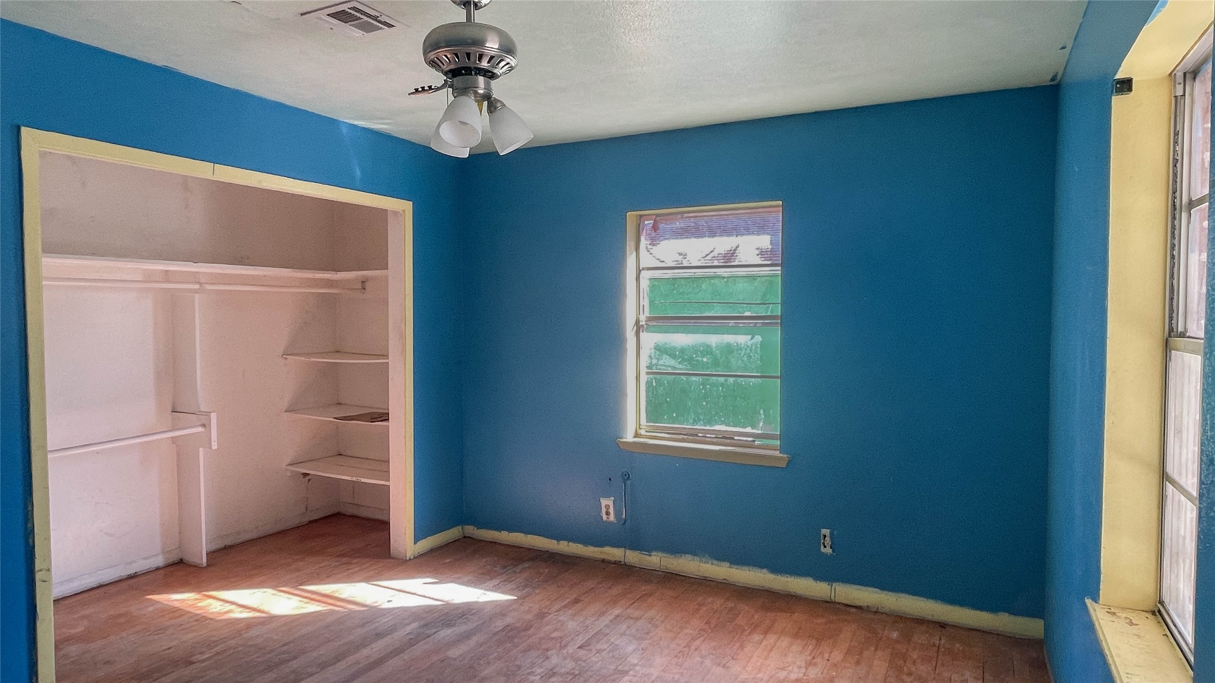 255 McFarland Road Houston, TX 77060 - Photo 15 of 28 a view of an empty room with a window and wooden floor