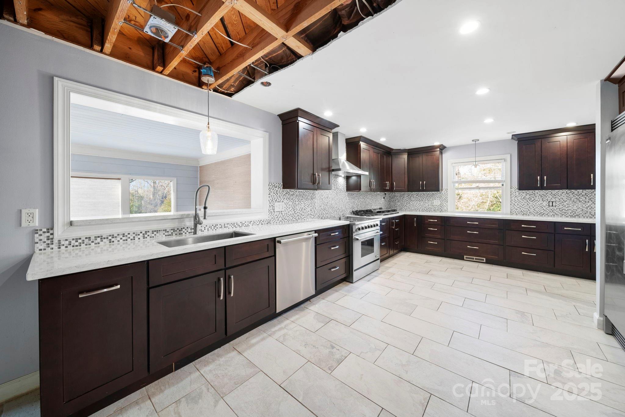 415 Love Lane Rockingham, NC 28379 - Photo 18 of 46 a large kitchen with a large counter space a sink and stainless steel appliances