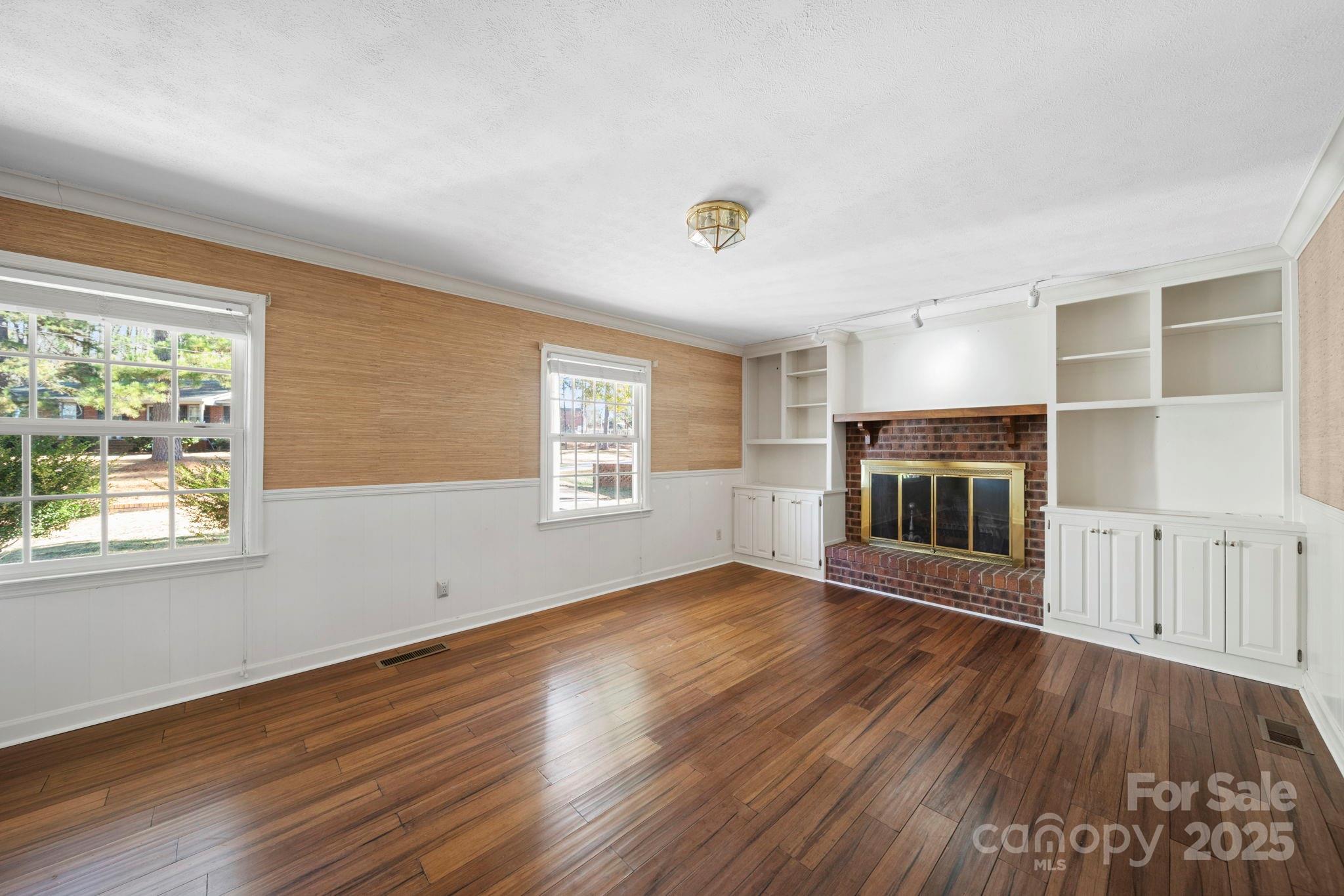 415 Love Lane Rockingham, NC 28379 - Photo 21 of 46 an empty room with wooden floor and windows