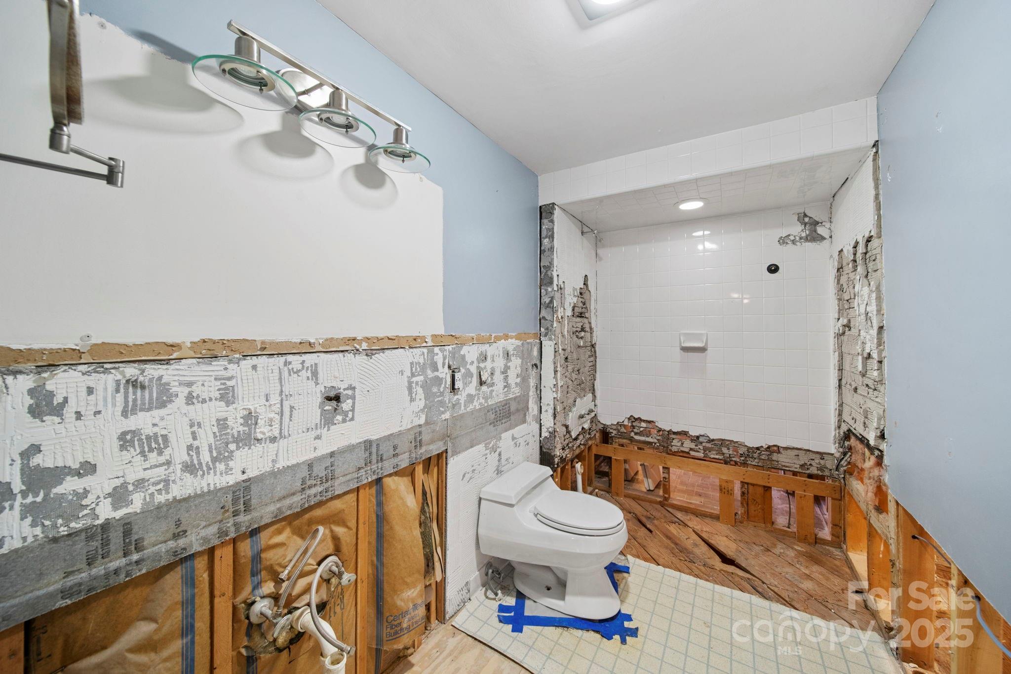 415 Love Lane Rockingham, NC 28379 - Photo 30 of 46 a bathroom with a toilet a sink and bathtub