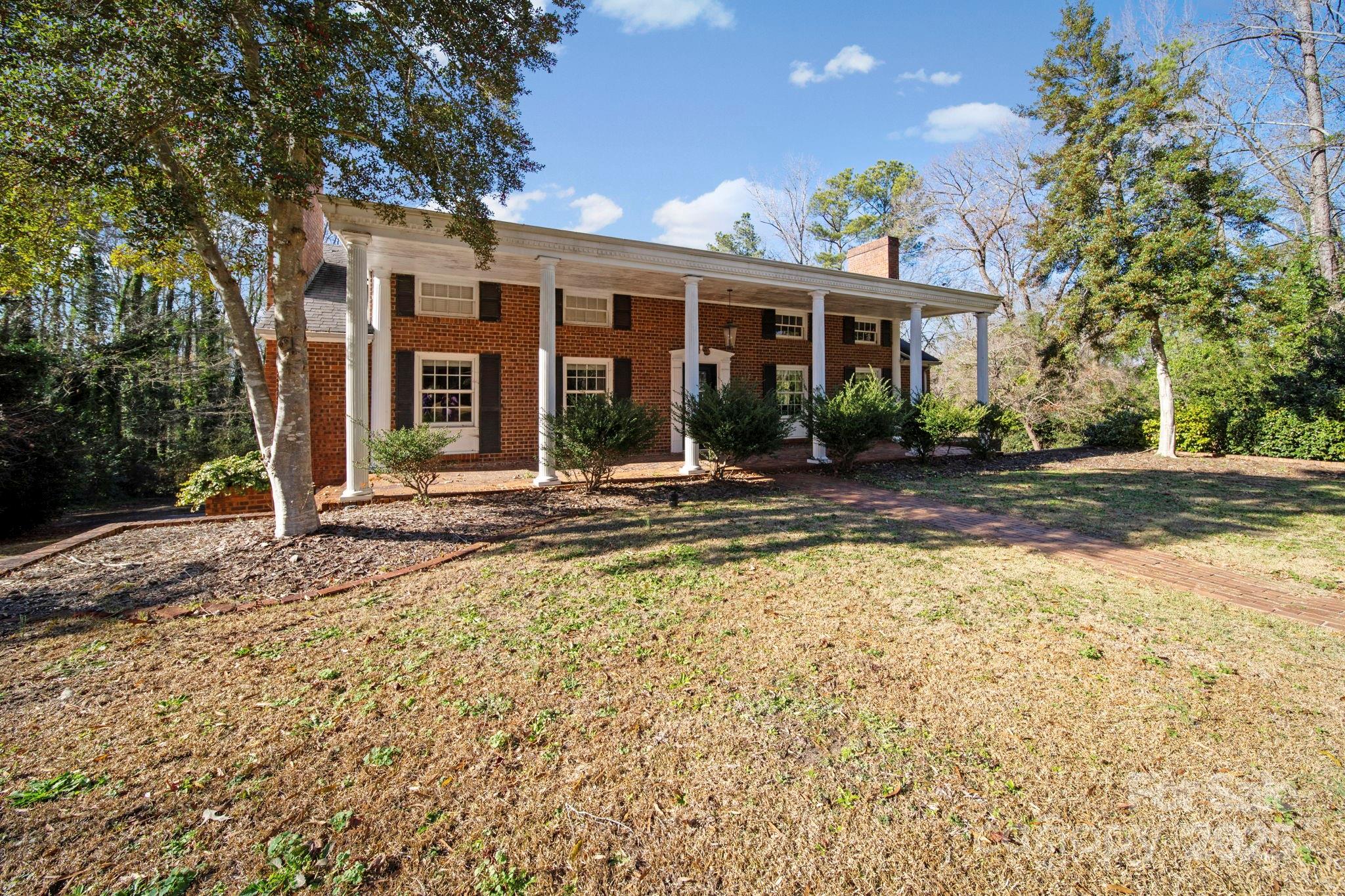 415 Love Lane Rockingham, NC 28379 - Photo 3 of 46 a front view of a house with a yard