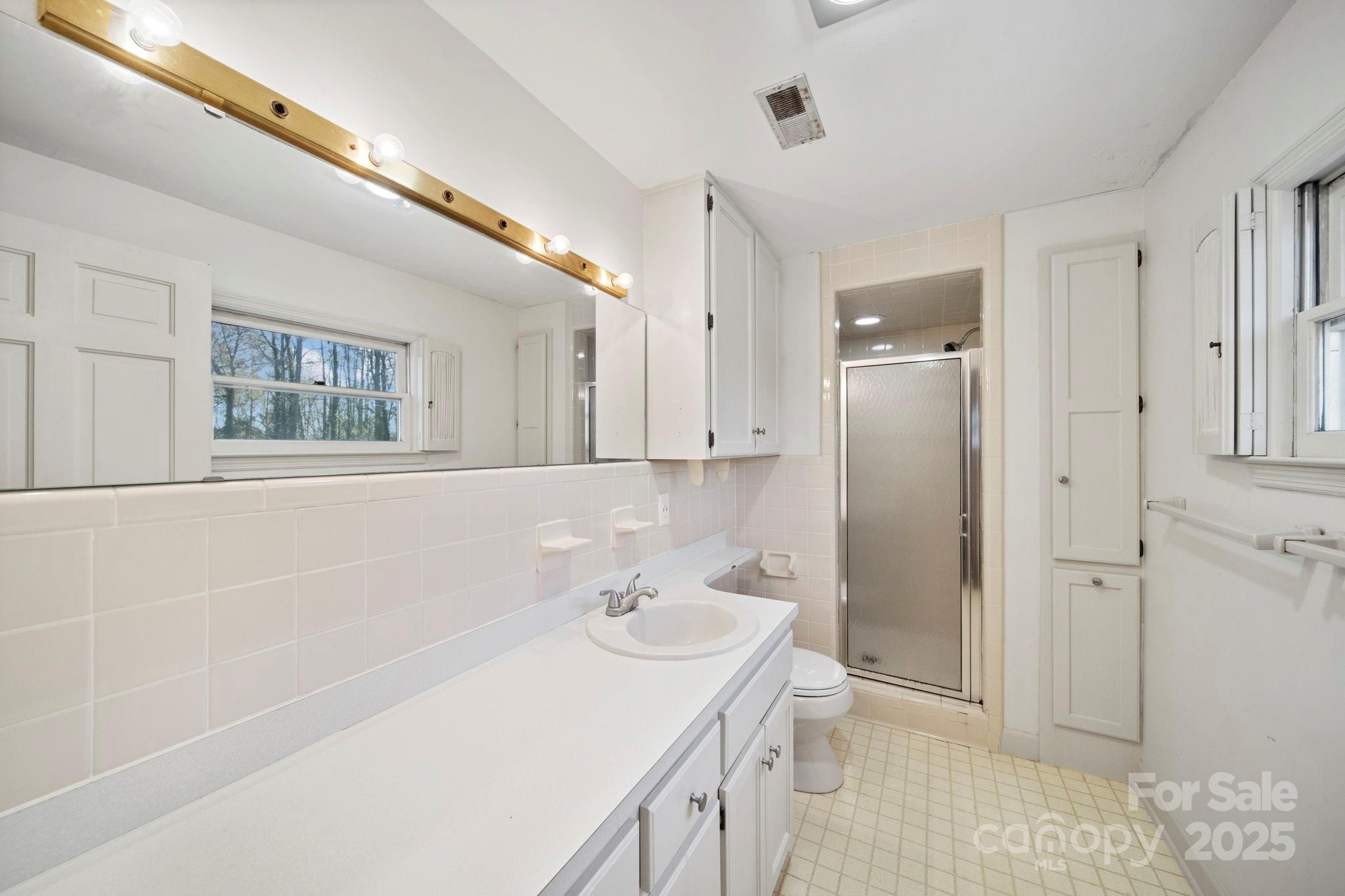 415 Love Lane Rockingham, NC 28379 - Photo 33 of 46 a bathroom with a sink a toilet and shower