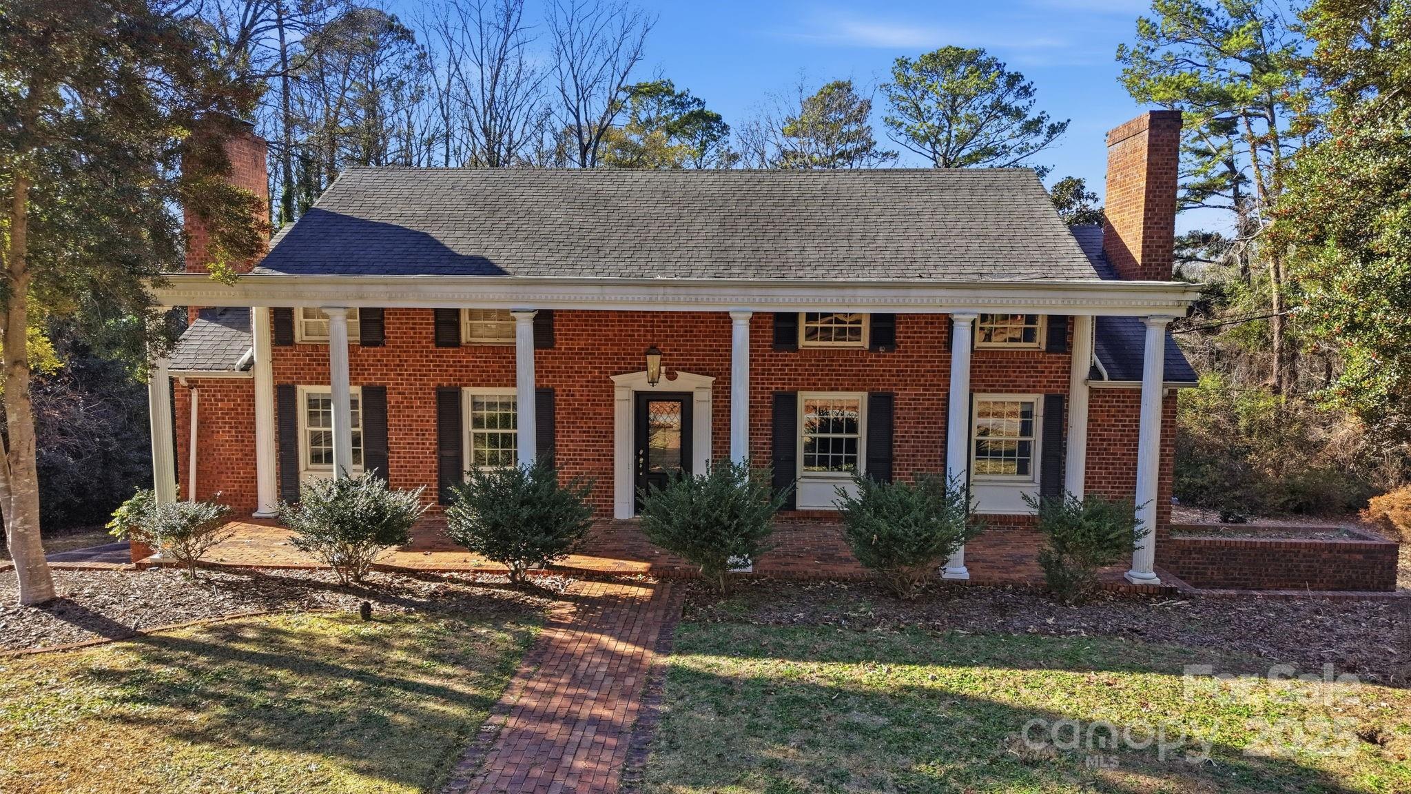 415 Love Lane Rockingham, NC 28379 - Photo 46 of 46 a front view of a house with garden