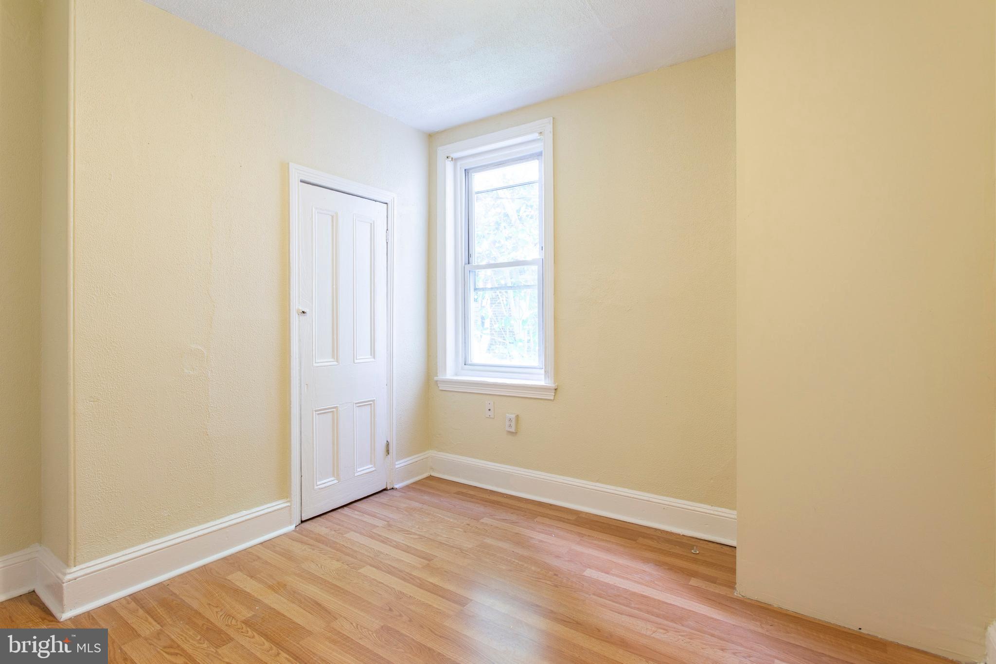 3911 Warren Street Philadelphia, PA 19104 - Photo 18 of 30 a view of an empty room with wooden floor and a window