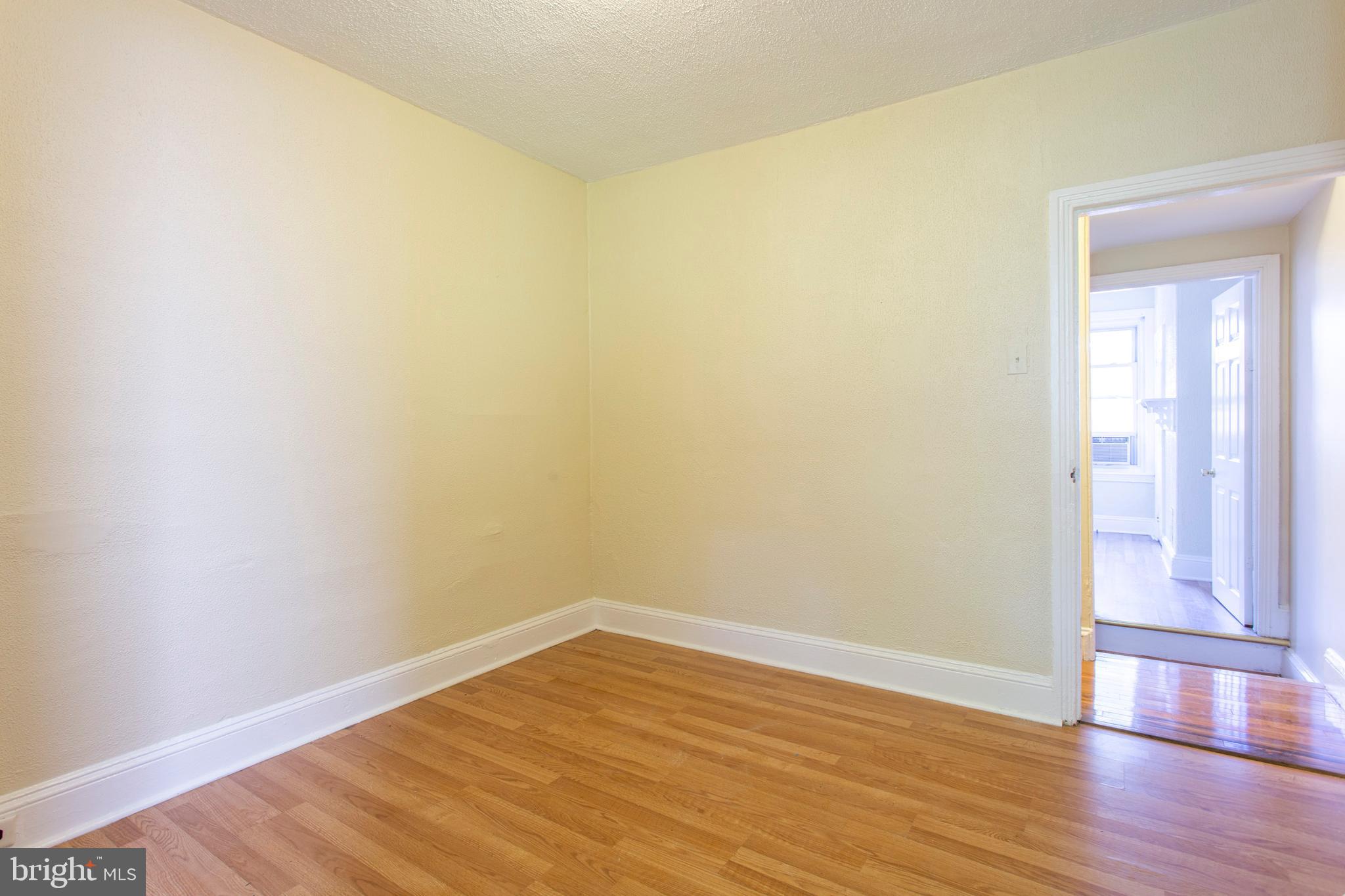 3911 Warren Street Philadelphia, PA 19104 - Photo 19 of 30 a view of an empty room with wooden floor and a window