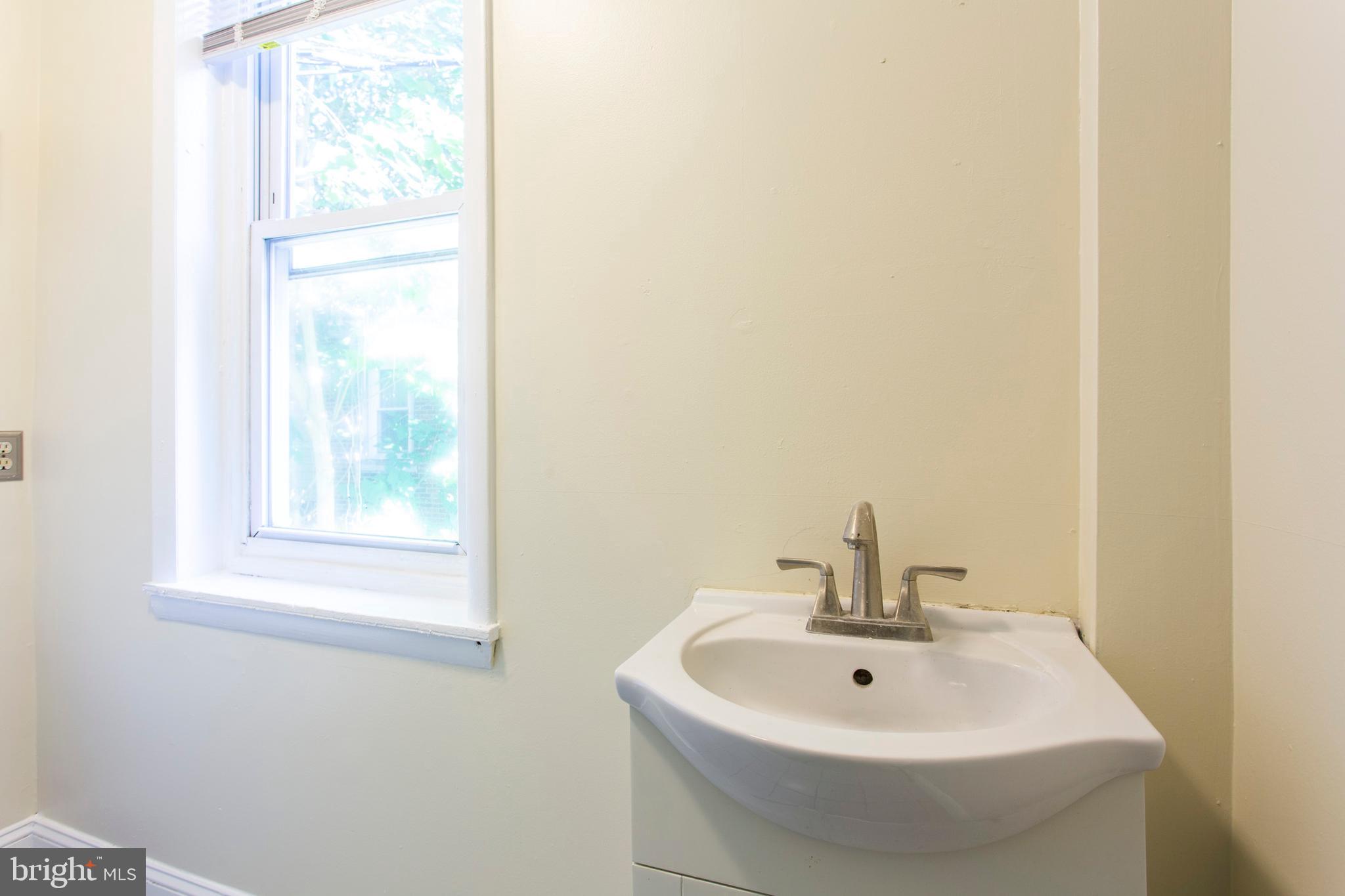 3911 Warren Street Philadelphia, PA 19104 - Photo 20 of 30 a bathroom with a sink and a window