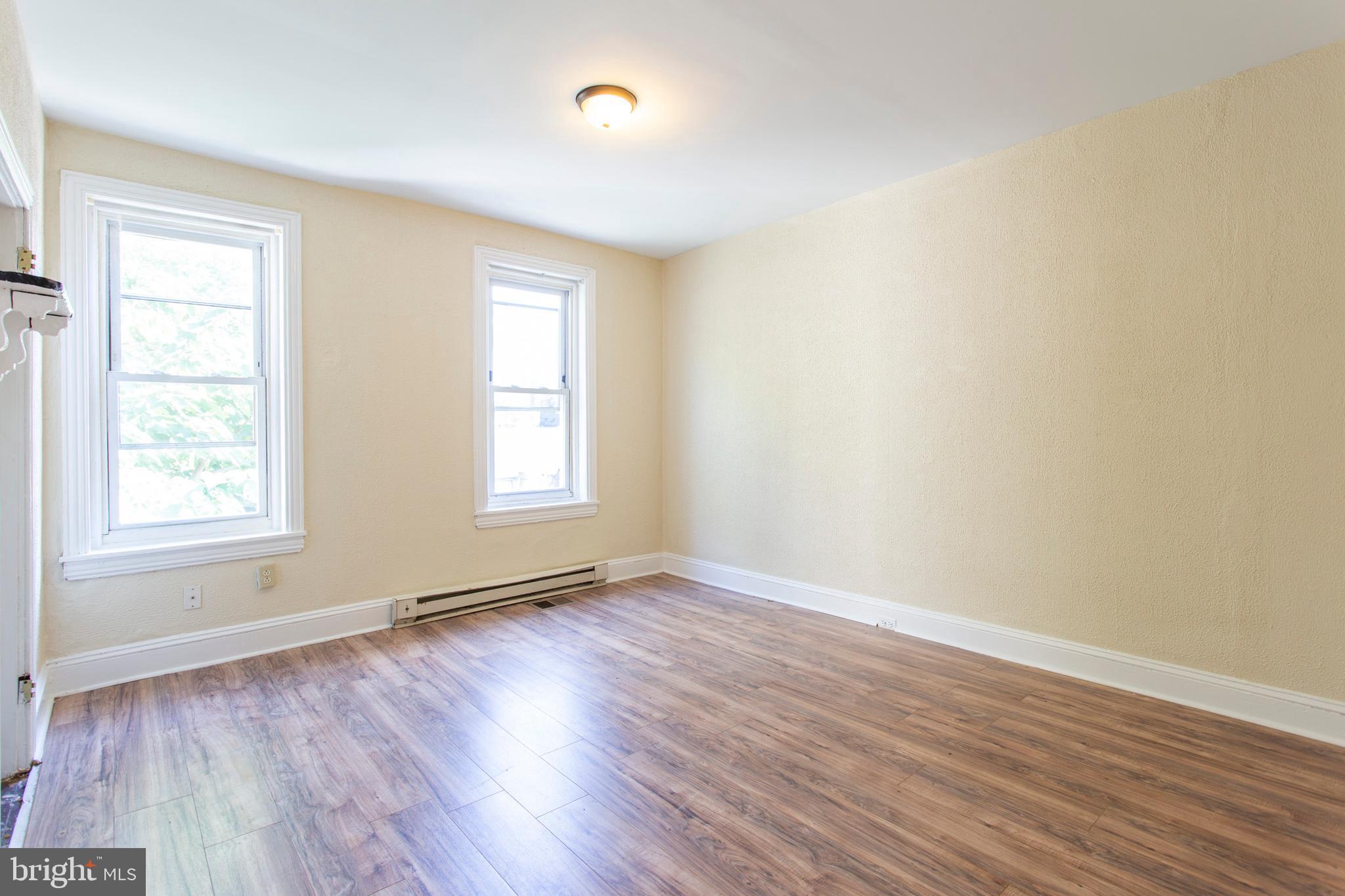 3911 Warren Street Philadelphia, PA 19104 - Photo 25 of 30 an empty room with wooden floor and windows
