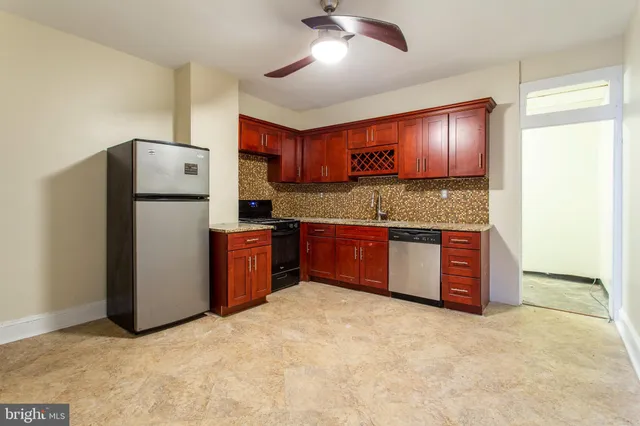 a kitchen with stainless steel appliances granite countertop a refrigerator and a stove