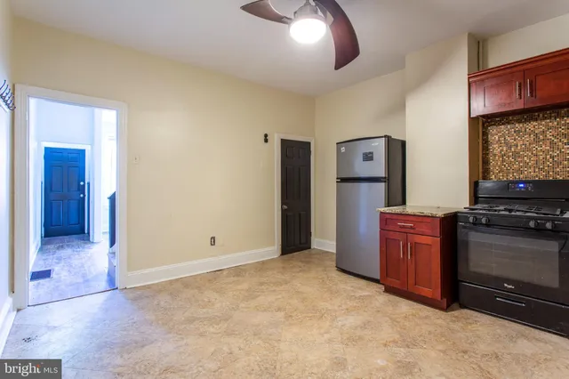 a kitchen with granite countertop a sink and cabinets