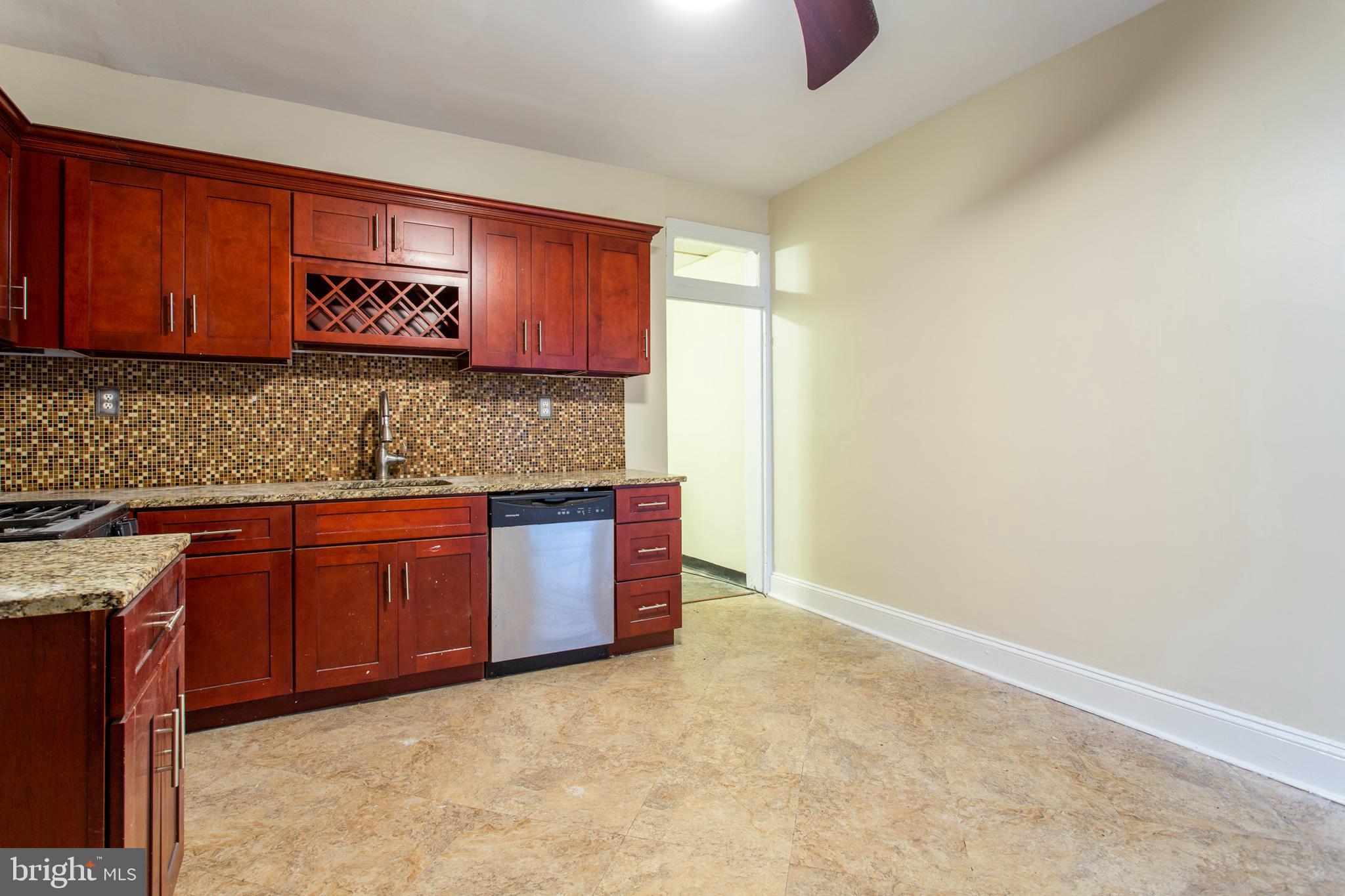 3911 Warren Street Philadelphia, PA 19104 - Photo 9 of 30 a kitchen with granite countertop a sink and cabinets
