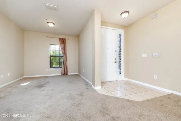 an empty room with windows and closet