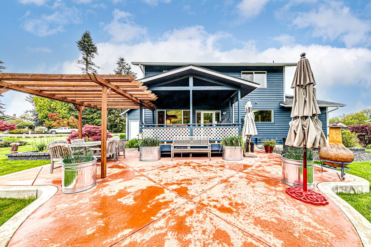 173 View Ridge Drive Port Angeles, WA 98362 - Photo 24 of 27 a view of a patio with a table and chairs under an umbrella