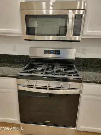 a stove top oven sitting inside of a kitchen