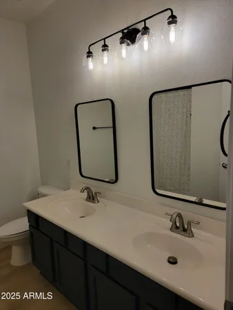 a bathroom with a sink double vanity and a mirror