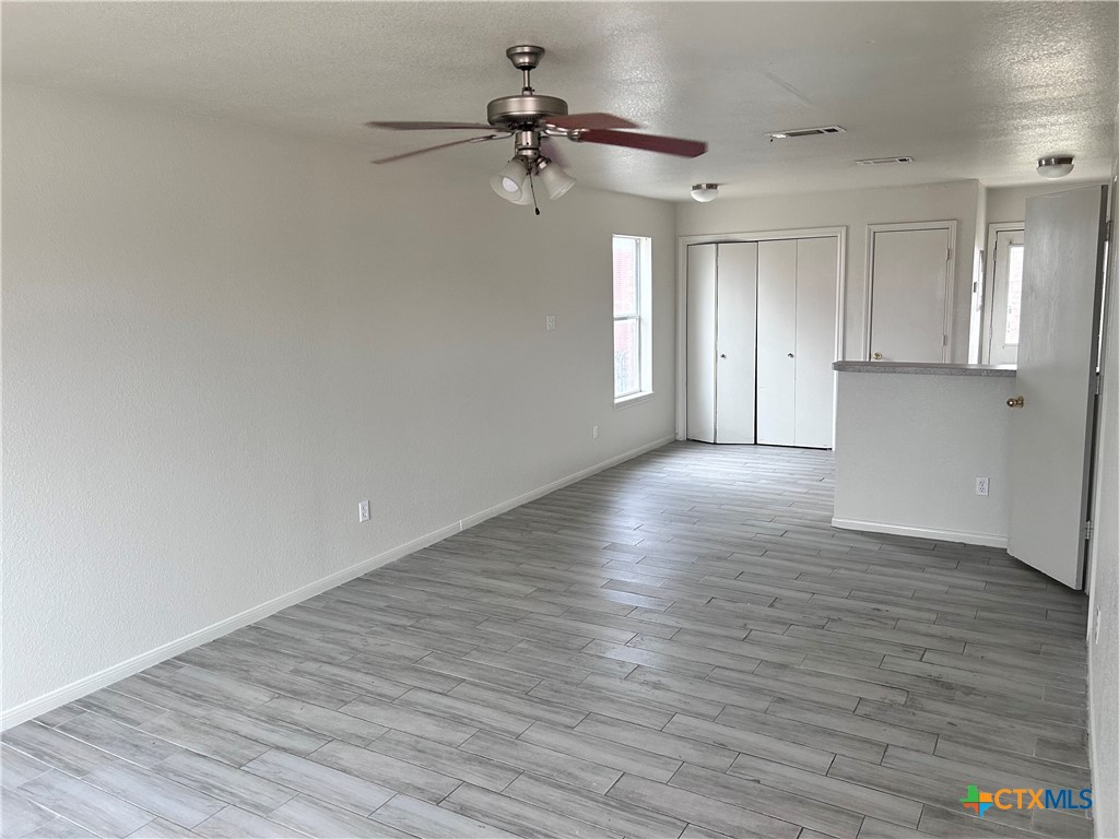 4103 Wine Cup, Unit C Copperas Cove, TX 76522 - Photo 2 of 8 a view of a livingroom with wooden floor and a ceiling fan