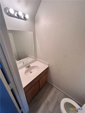 a bathroom with a sink mirror and vanity