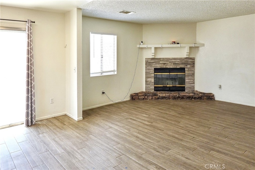 10403 Buckboard Circle Adelanto, CA 92301 - Photo 1 of 20 a view of a livingroom with a fireplace and window