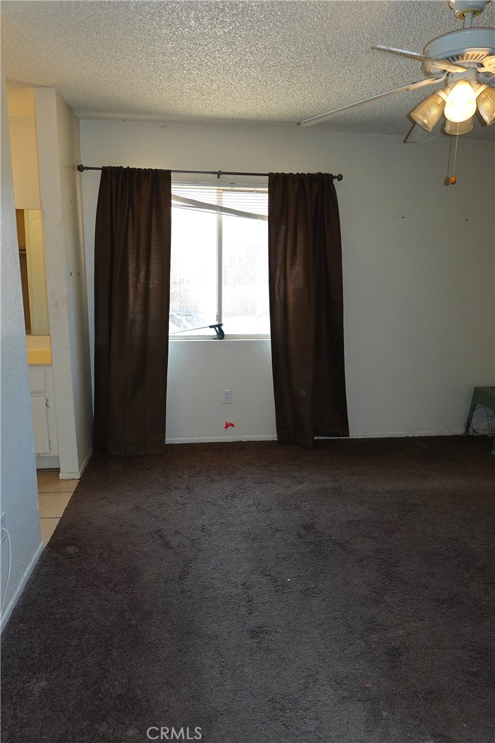 10403 Buckboard Circle Adelanto, CA 92301 - Photo 13 of 20 an empty room with windows and closet