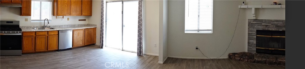 10403 Buckboard Circle Adelanto, CA 92301 - Photo 18 of 20 a view of a kitchen with wooden floor and a window