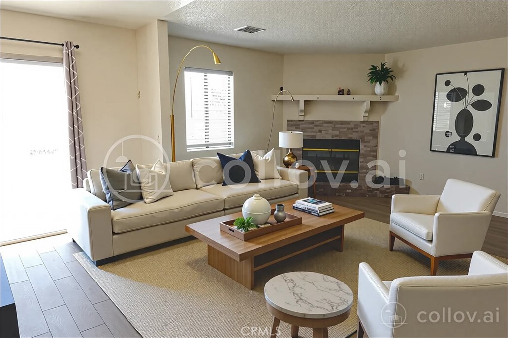10403 Buckboard Circle Adelanto, CA 92301 - Photo 20 of 20 a living room with furniture and a fireplace