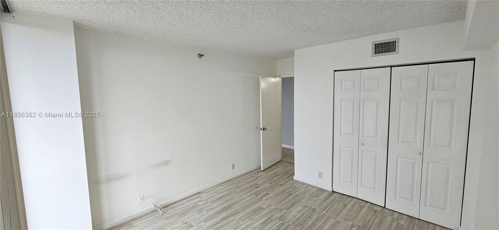 3300 Northeast 191st Street, Unit PH8 Aventura, FL 33180 - Photo 13 of 35 a view of a hallway with wooden floor