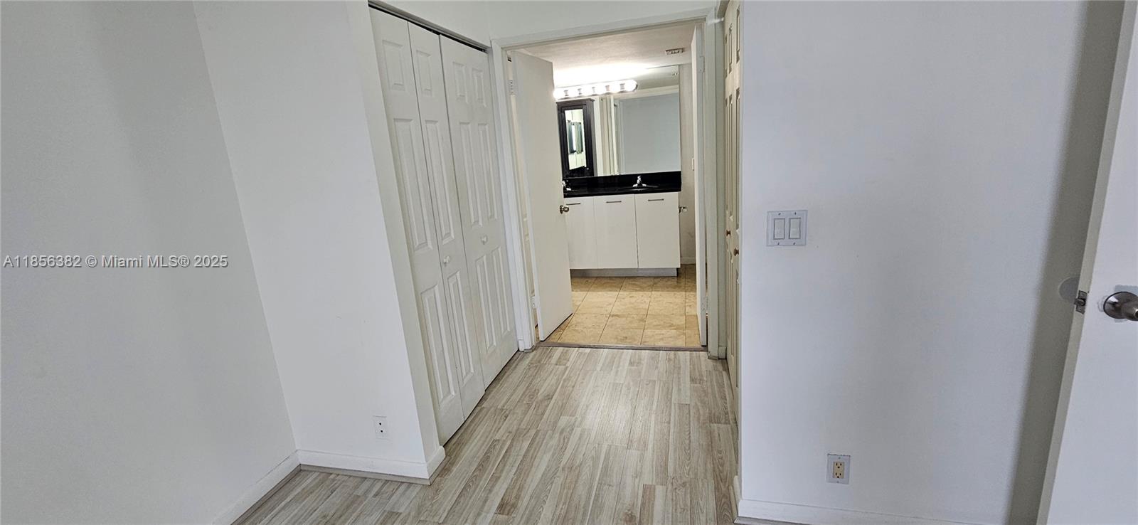 3300 Northeast 191st Street, Unit PH8 Aventura, FL 33180 - Photo 18 of 35 a view of a hallway with wooden floor