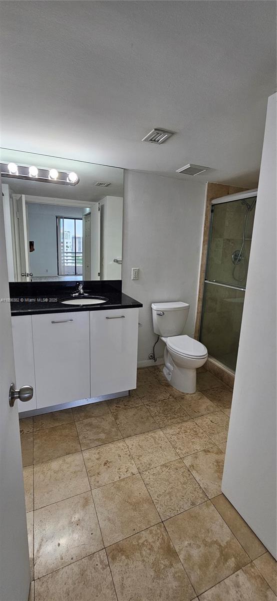 3300 Northeast 191st Street, Unit PH8 Aventura, FL 33180 - Photo 19 of 35 a bathroom with a sink a toilet and mirror