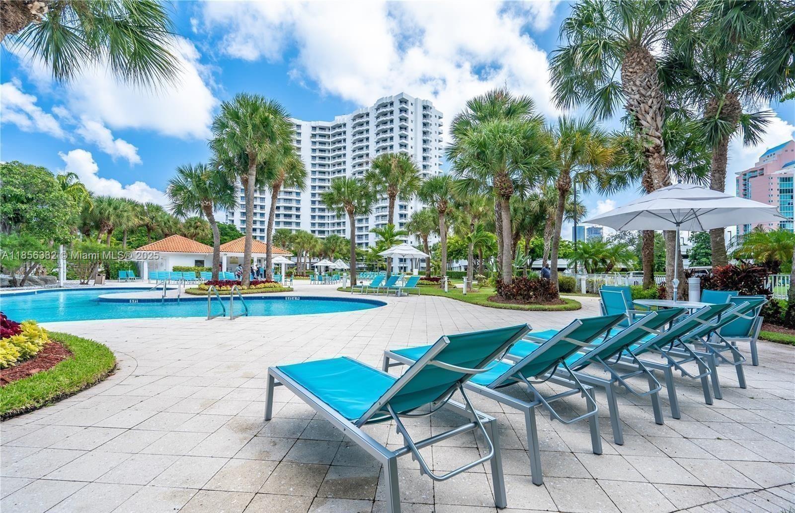 3300 Northeast 191st Street, Unit PH8 Aventura, FL 33180 - Photo 24 of 35 a view of swimming pool and lounge chair