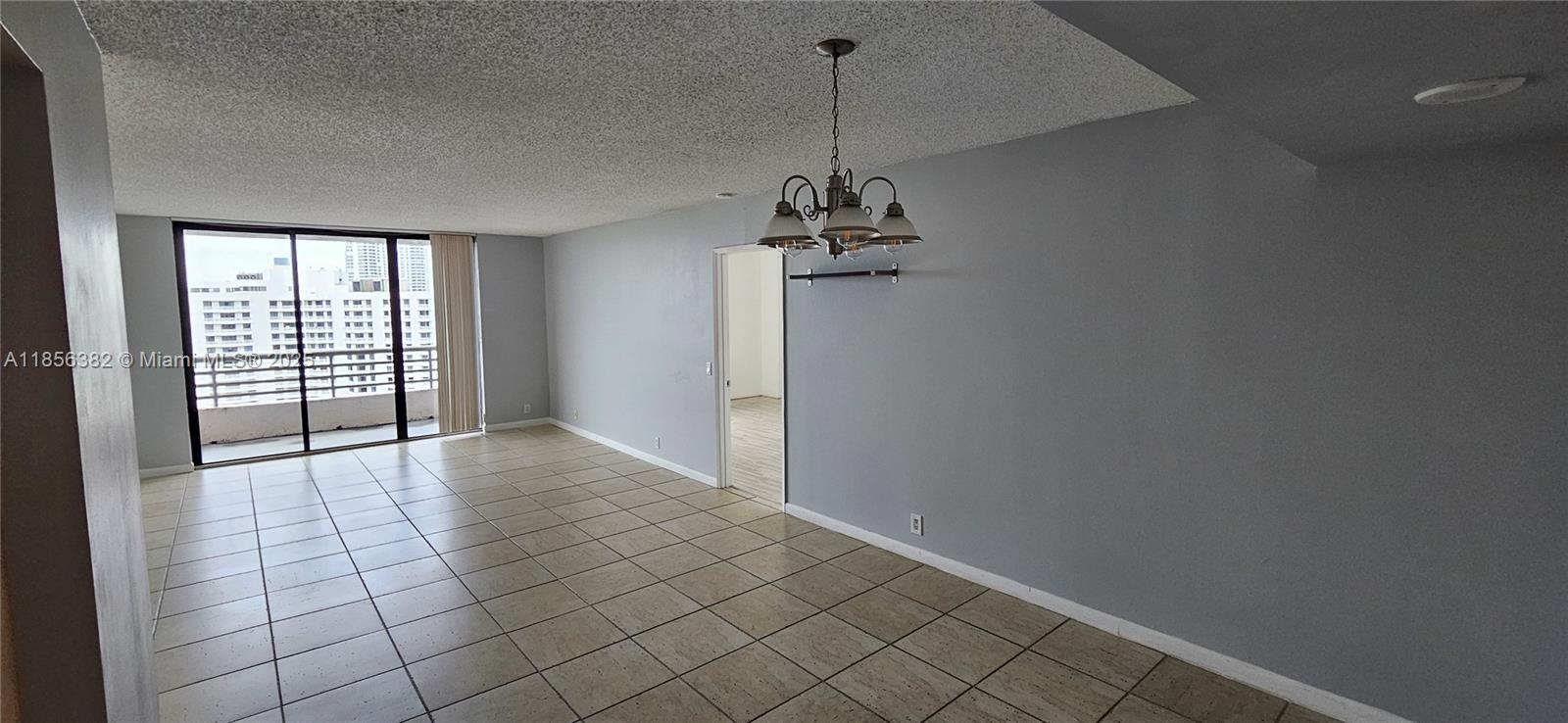 3300 Northeast 191st Street, Unit PH8 Aventura, FL 33180 - Photo 3 of 35 a view of empty room with wooden floor and fan