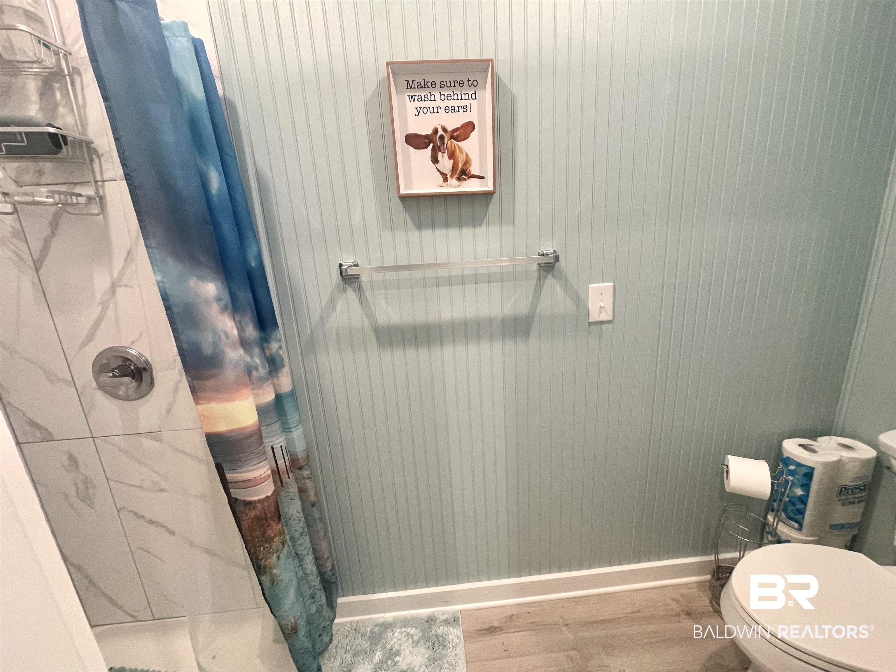 4650 Griffith Marina Road, Unit 22 Orange Beach, AL 36561 - Photo 16 of 25 Bathroom with a shower with curtain and wood finished floors