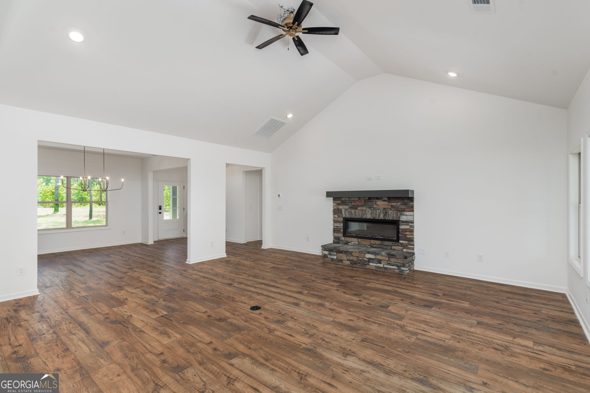 297 Bishop Road Meansville, GA 30256 - Photo 13 of 77 a view of empty room with wooden floor and window