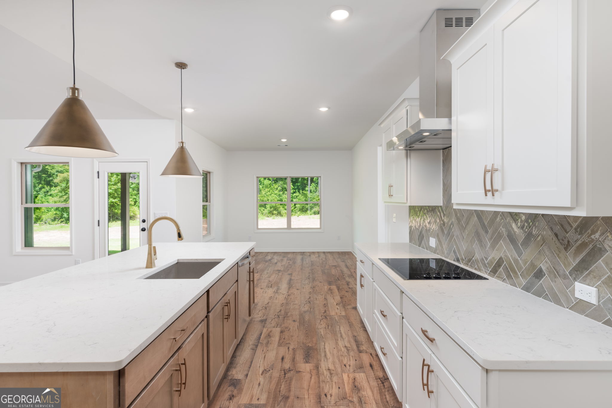 297 Bishop Road Meansville, GA 30256 - Photo 15 of 77 a kitchen with kitchen island granite countertop a sink a counter top space and cabinets