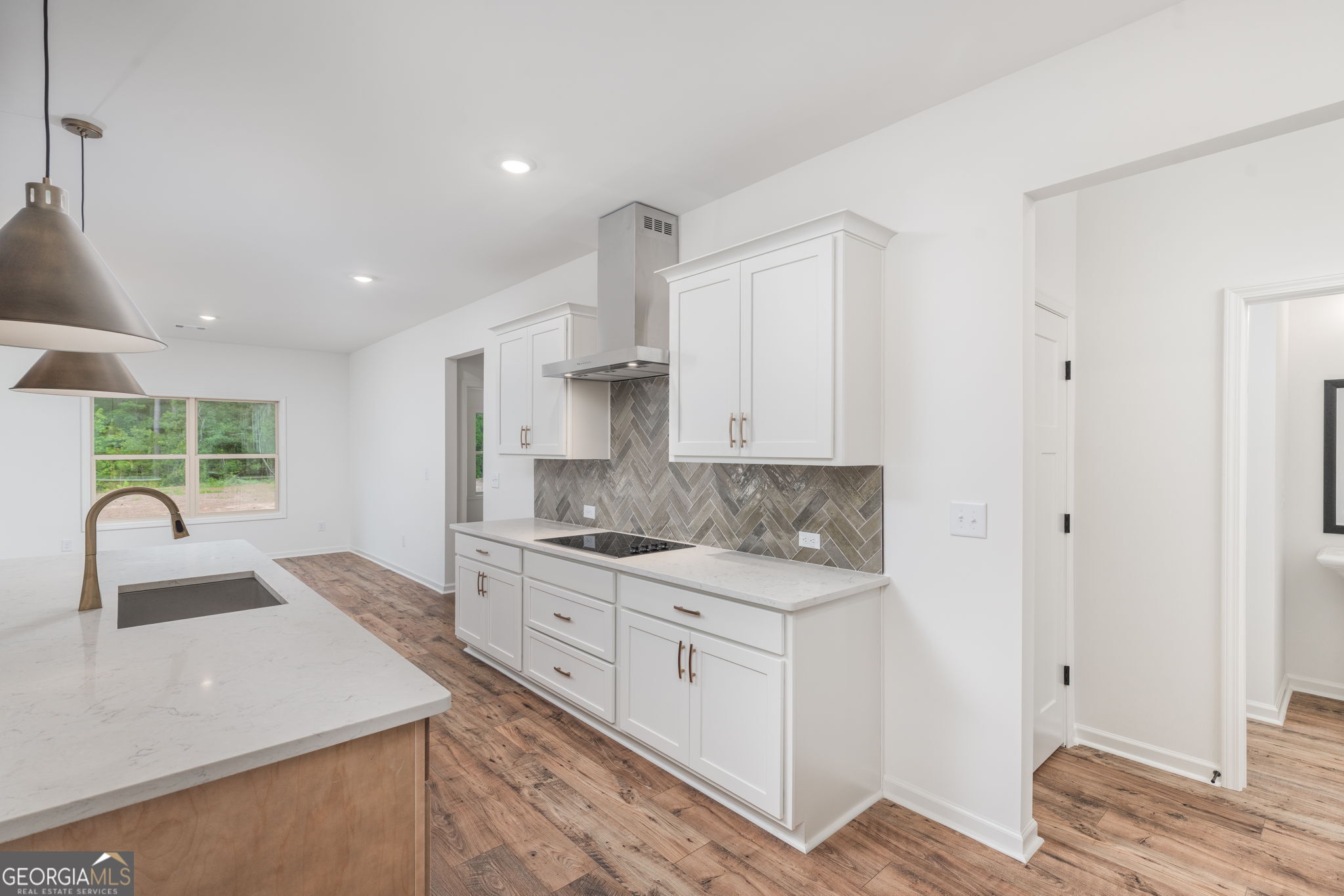 297 Bishop Road Meansville, GA 30256 - Photo 16 of 77 a kitchen with a sink stove and cabinets