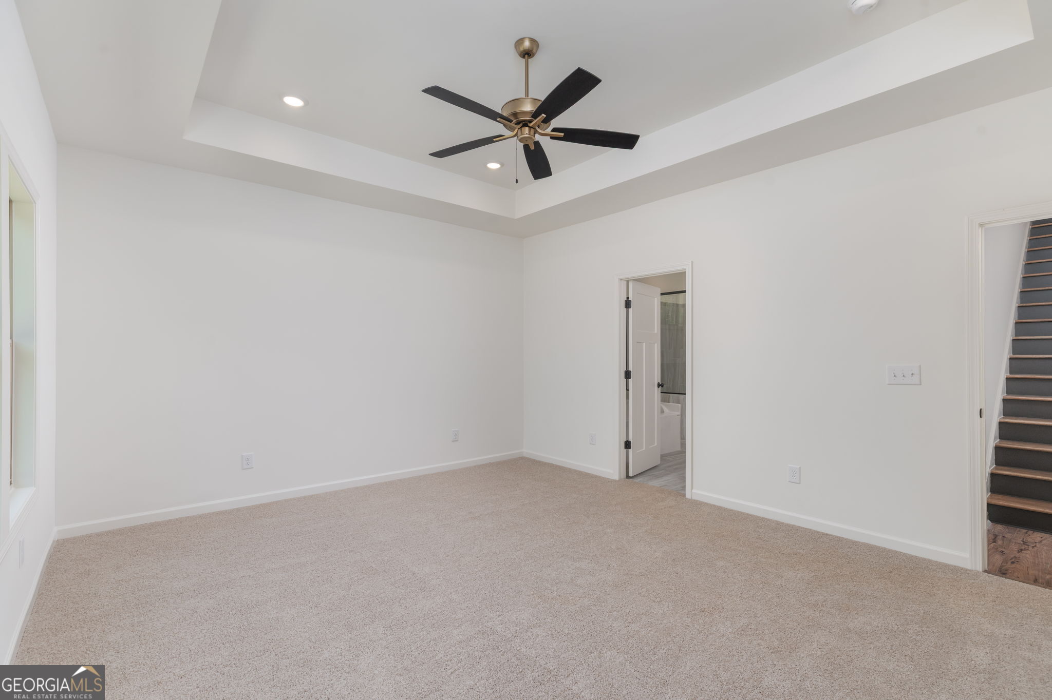 297 Bishop Road Meansville, GA 30256 - Photo 26 of 77 an empty room with closet and ceiling fan