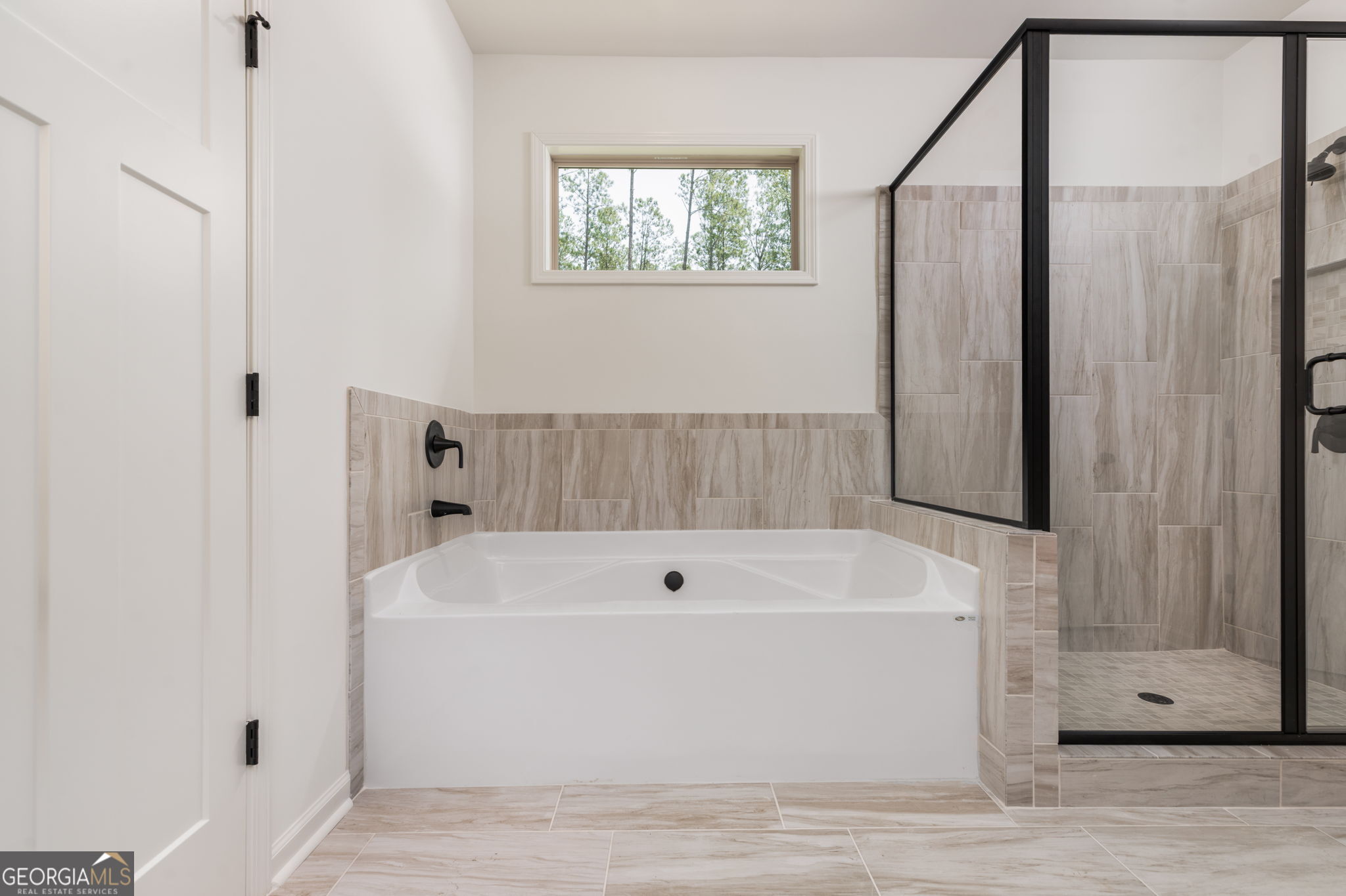 297 Bishop Road Meansville, GA 30256 - Photo 30 of 77 a view of bathroom with bathtub and window