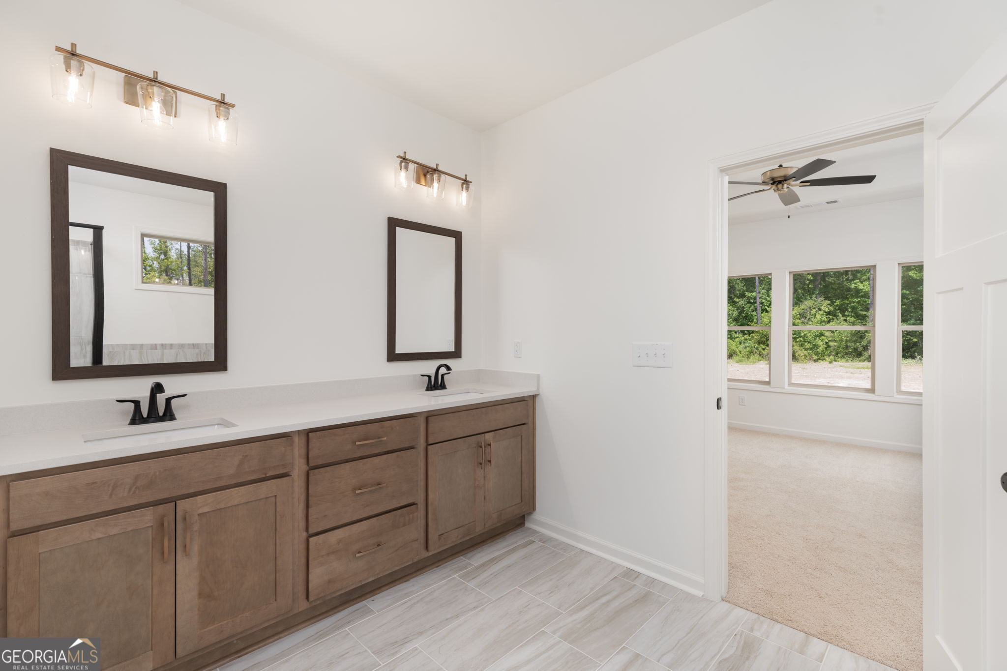 297 Bishop Road Meansville, GA 30256 - Photo 31 of 77 a bathroom with double vanity sink a two mirror a window and vanity