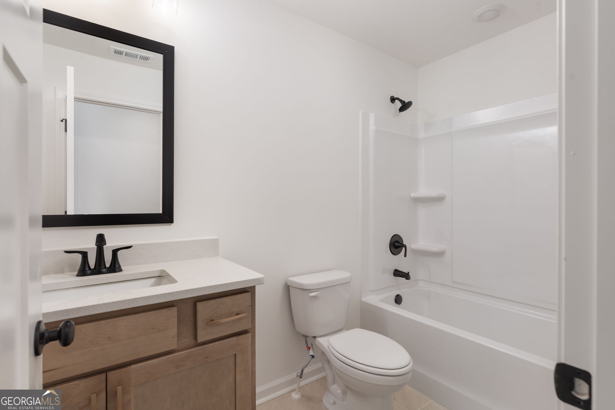 297 Bishop Road Meansville, GA 30256 - Photo 42 of 77 a bathroom with a sink toilet vanity and shower