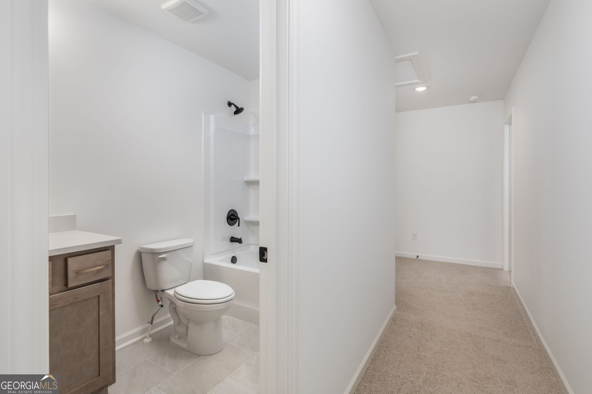 297 Bishop Road Meansville, GA 30256 - Photo 43 of 77 a white toilet sitting next to a white cabinet