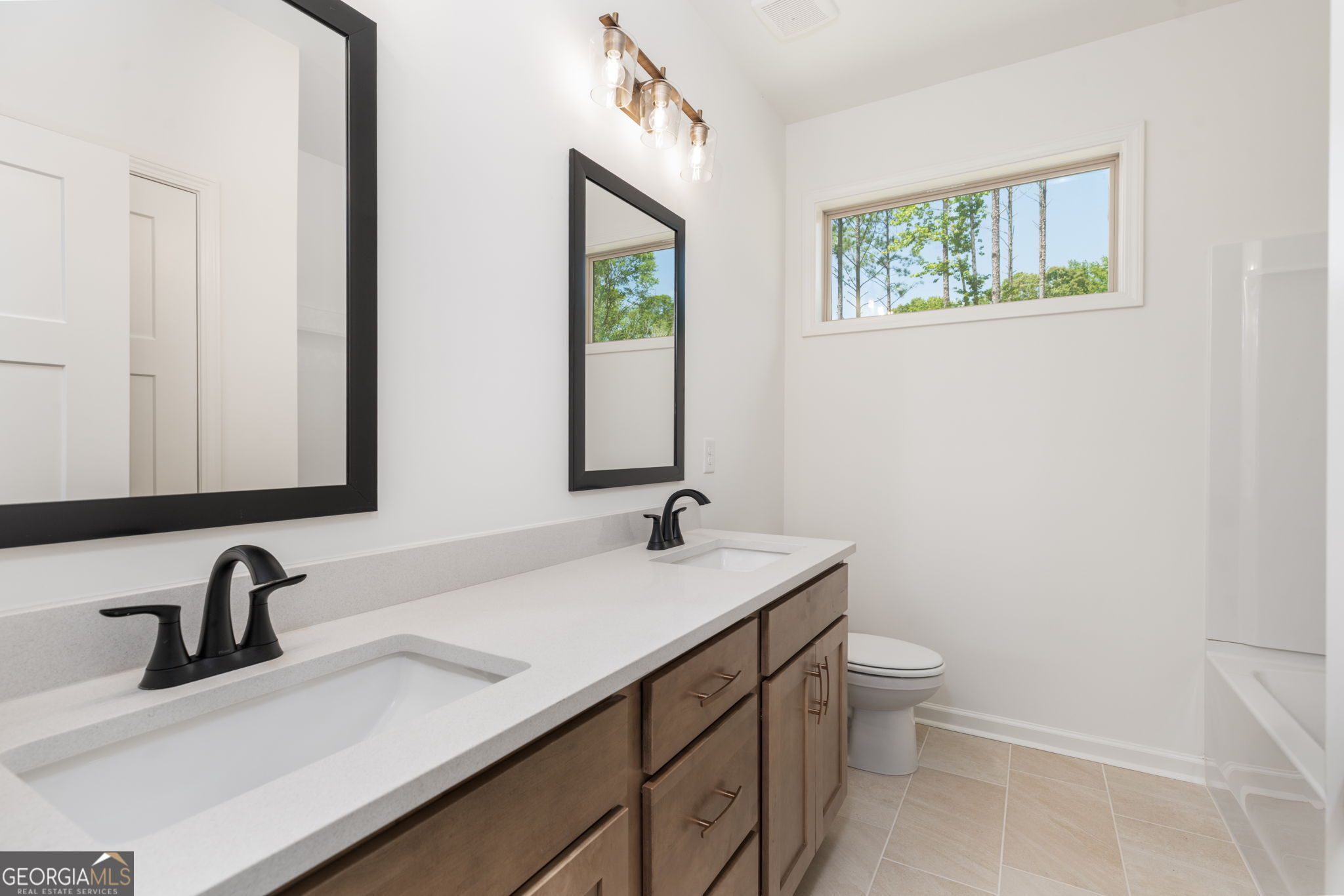 297 Bishop Road Meansville, GA 30256 - Photo 47 of 77 a bathroom with a toilet sink and mirror