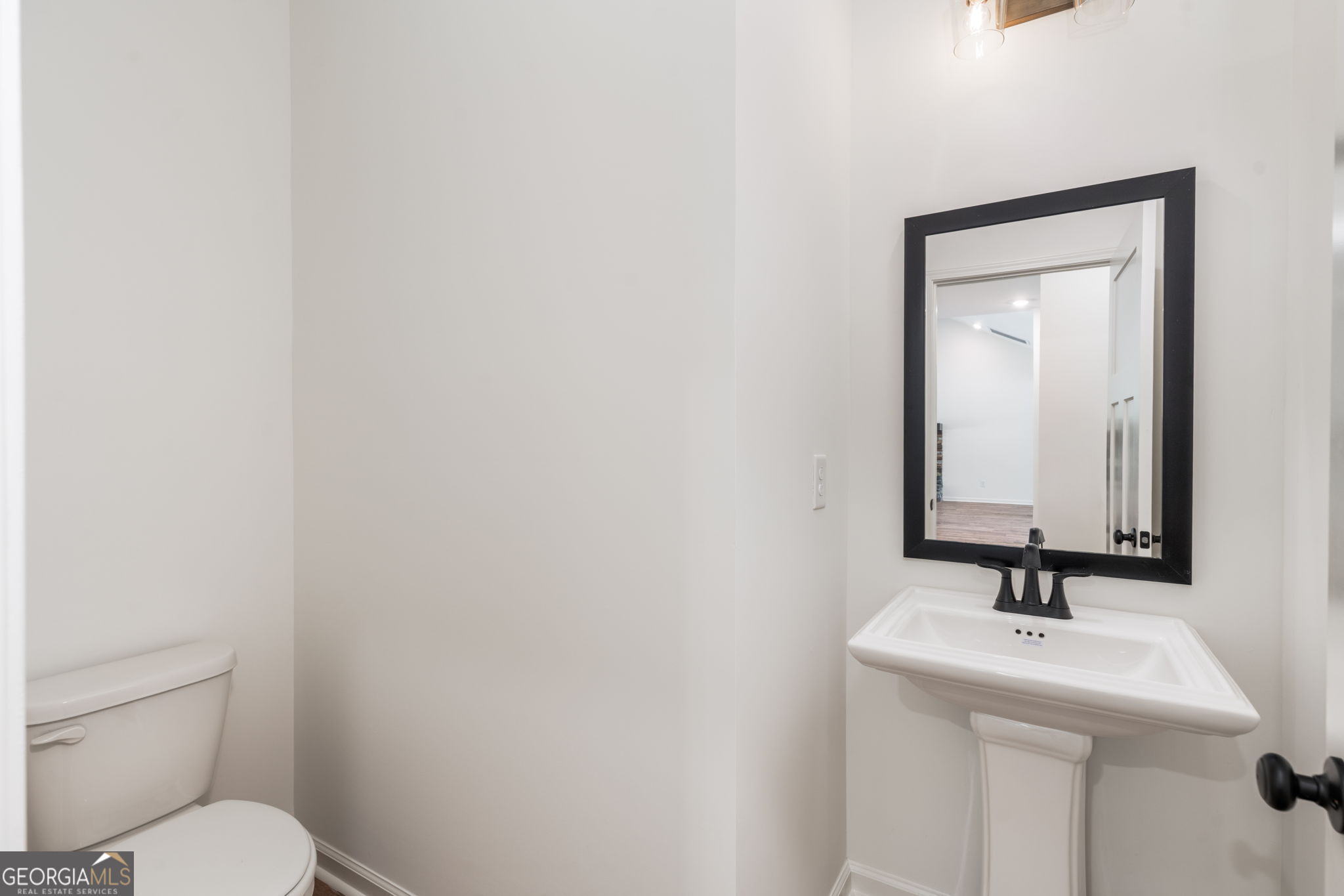 297 Bishop Road Meansville, GA 30256 - Photo 54 of 77 a bathroom with a toilet a sink and mirror