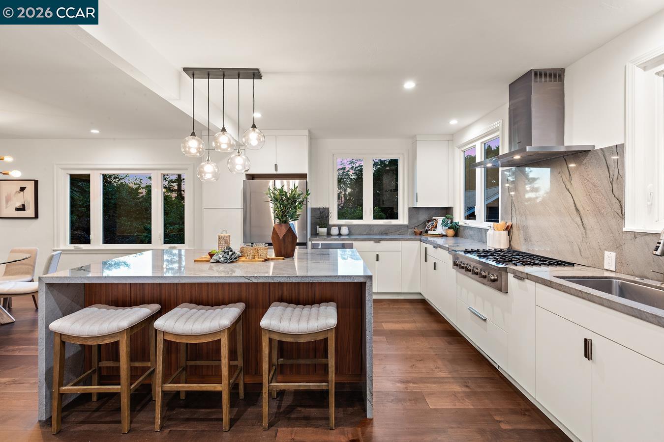 85 Ardmore Road Kensington, CA 94707 - Photo 15 of 45 a kitchen with stainless steel appliances granite countertop table chairs sink and cabinets