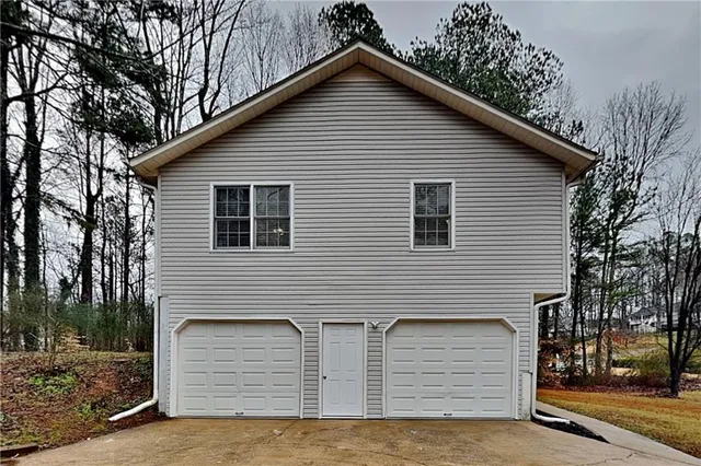 a view of a house with a yard and garage