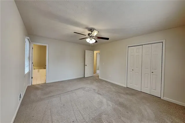 a view of an empty room with a ceiling fan